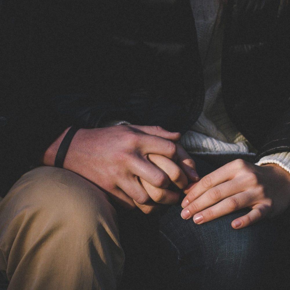 a-close-up-of-two-people-holding-hands-unsplash