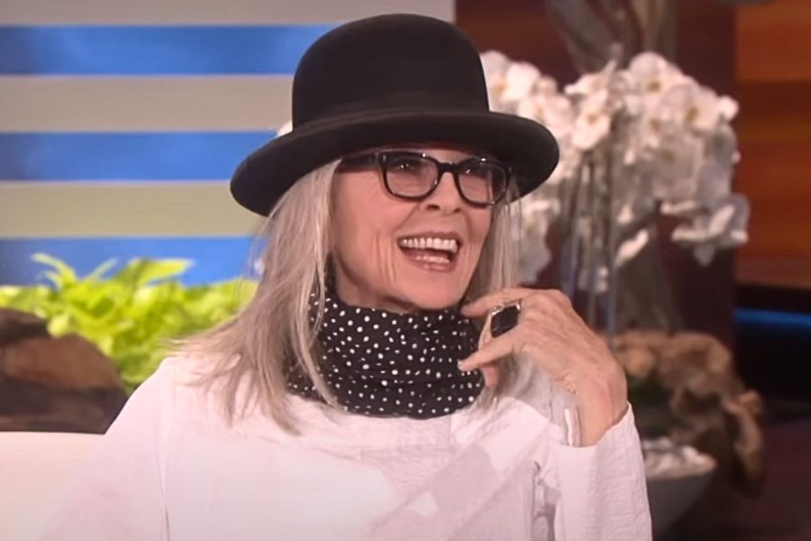 Γυναίκα με μαύρο καπέλο, γυαλιά και φουλάρι στο λαιμό