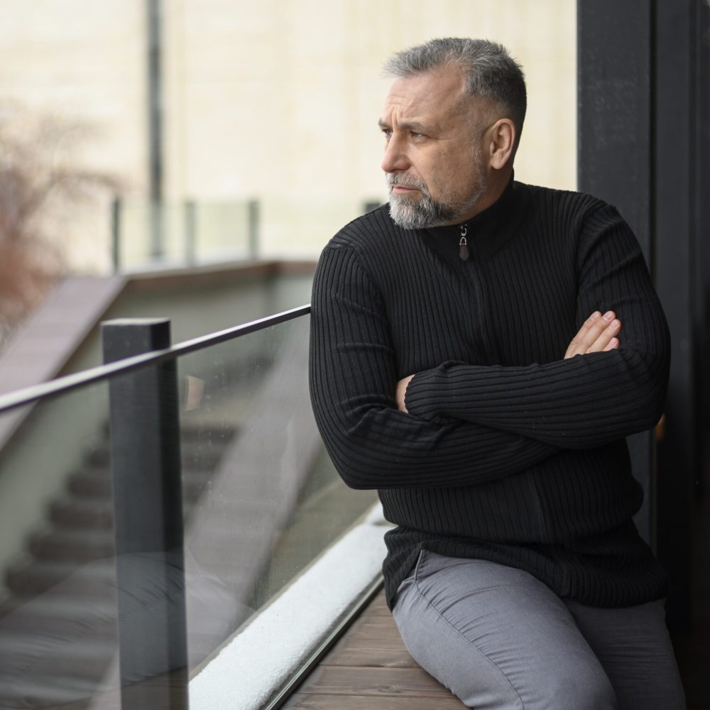 medium-shot-man-sitting-sill