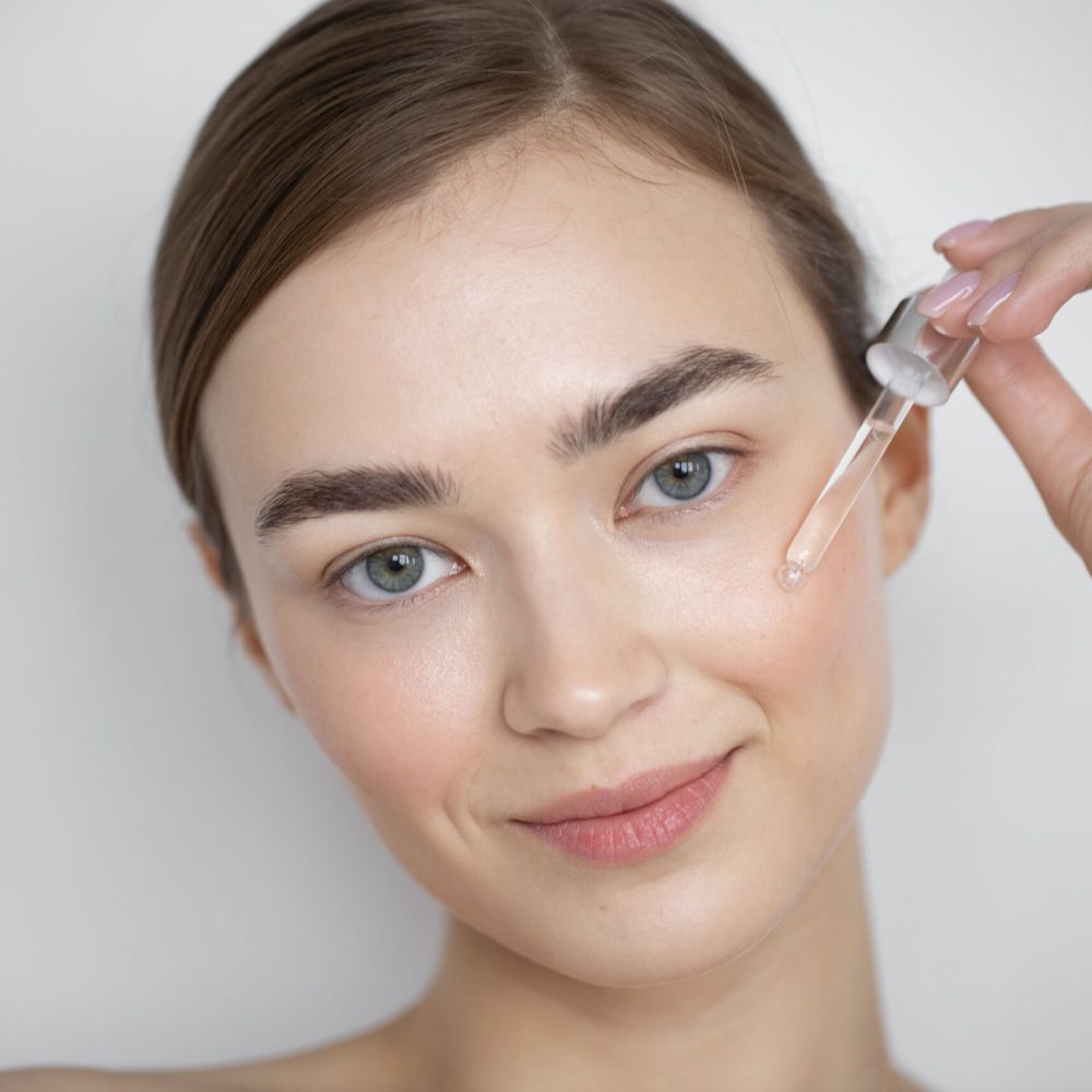 portrait-beautiful-woman-with-clear-skin-using-face-serum (1)